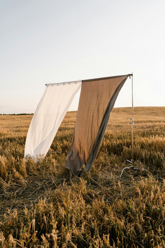 Second Shooter Digital SEO for wedding photographers brown and white sheet hanging in field at golden hour