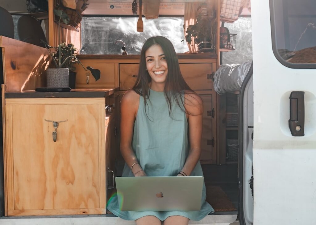 jane sitting in a van with a laptop, co founder and CTO of second shooter digital, a digital marketing agency for wedding photographers