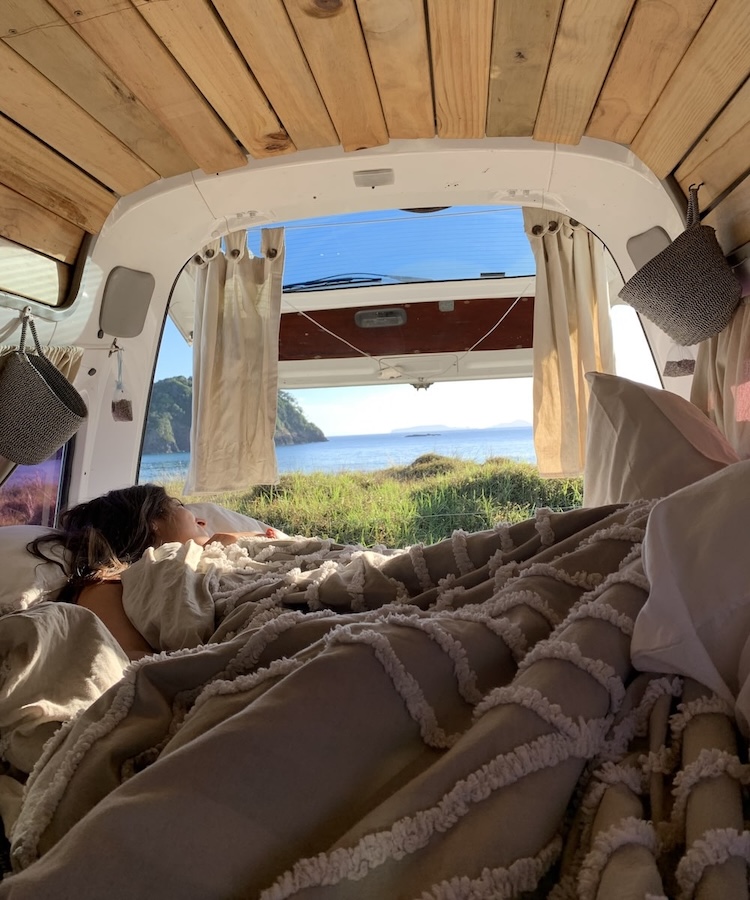 jane in her campervan looking at the ocean while traveling in new zealand, part of the inspiration behind second shooter digital